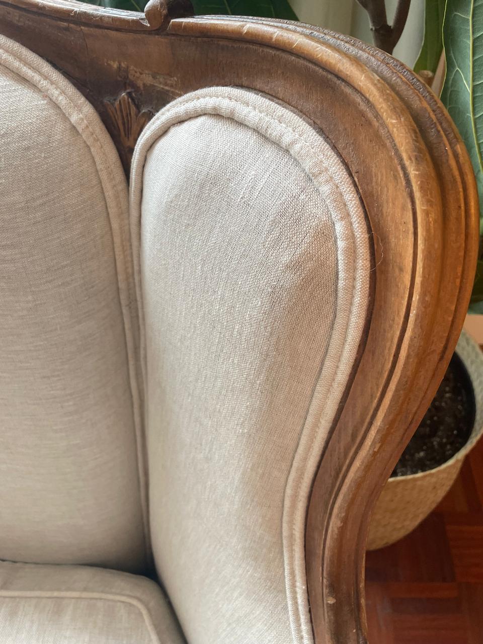 Close-up of piping and upholstery around the wooden sofa frame